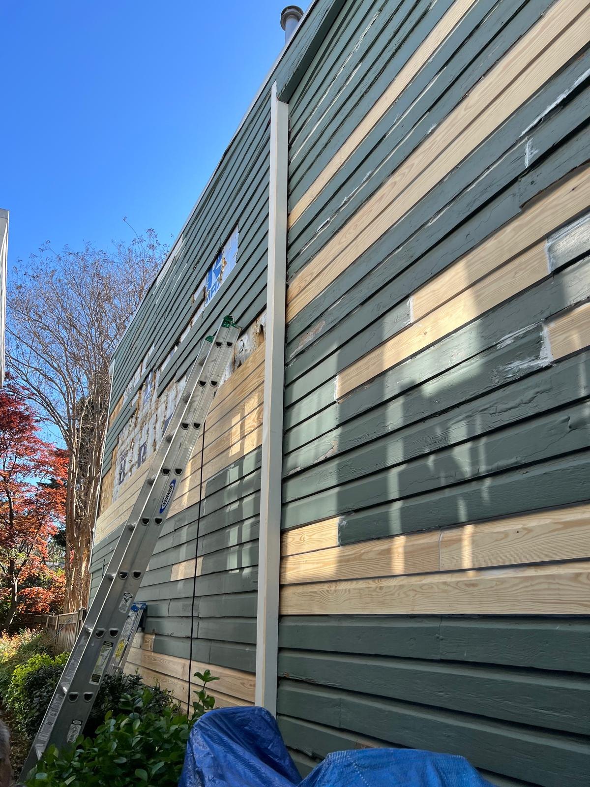 New timber boards fitted during exterior siding repairs.