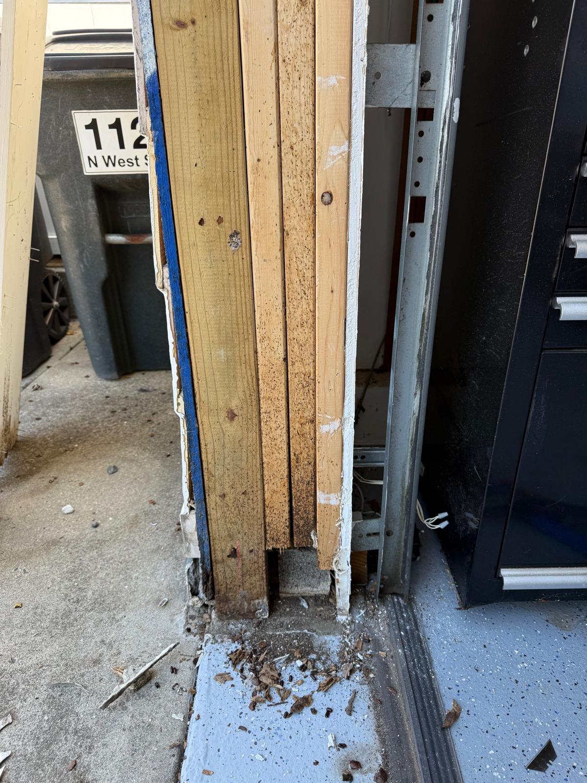 Closer view of the exposed lower jamb and threshold during the replacement work.