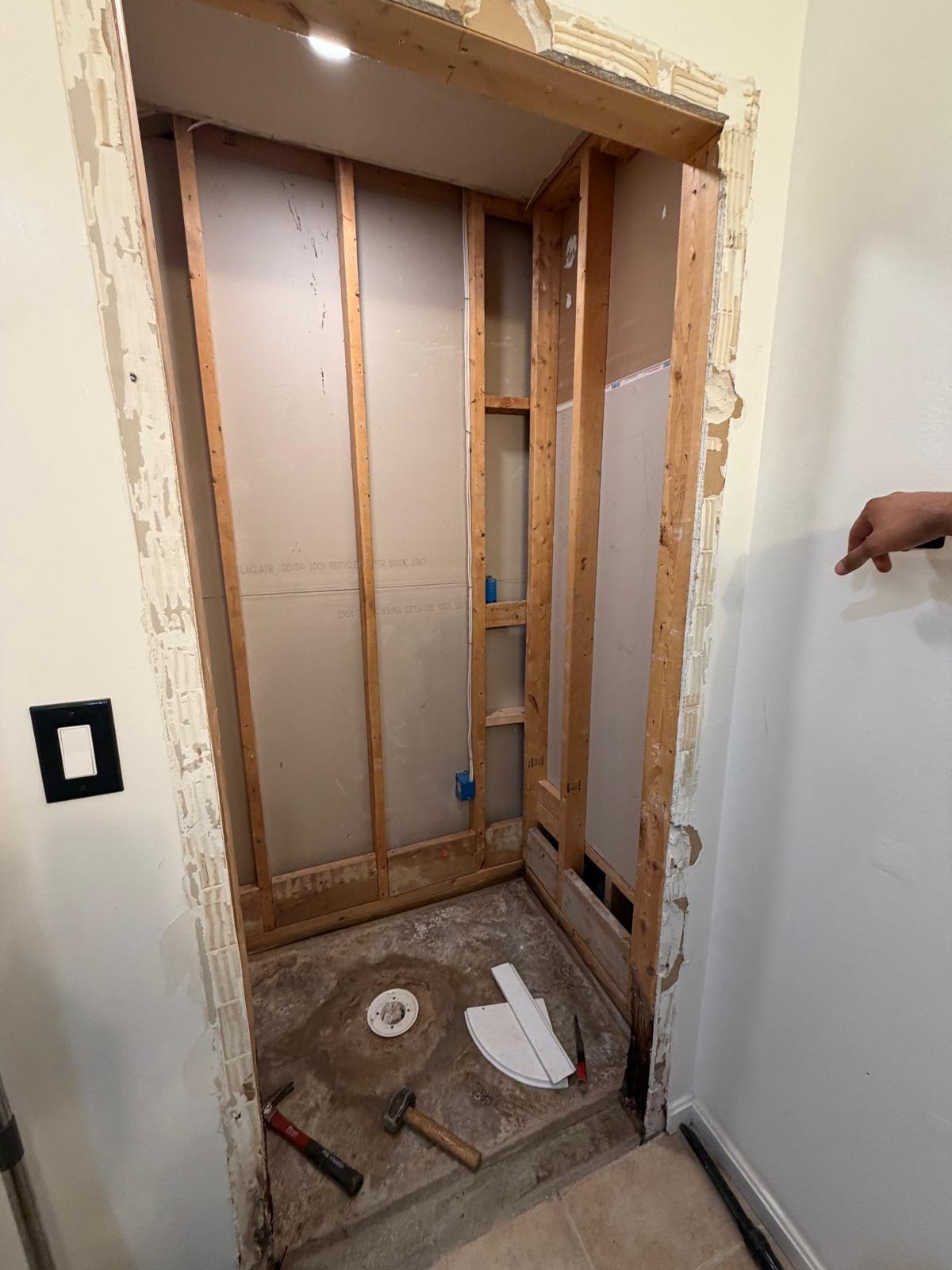 The enclosure stripped back to timber framing with the base area exposed.